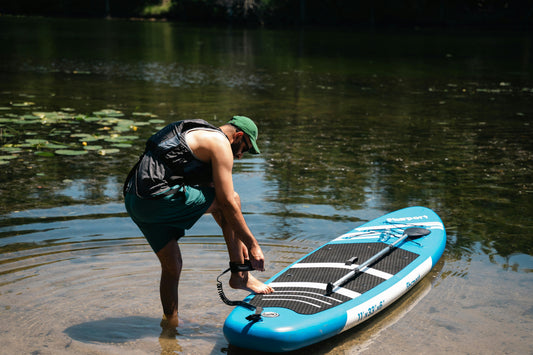 Man preparing to paddleboard on lake