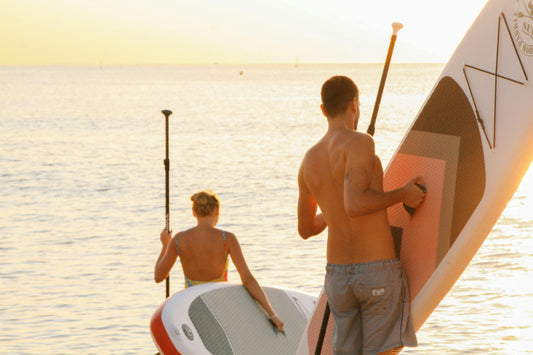 Paddleboarders at sunrise
